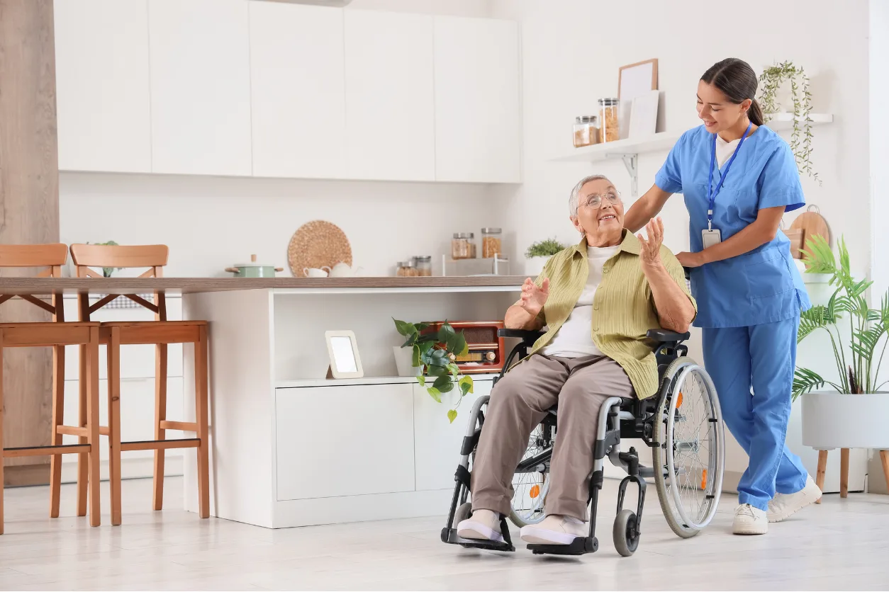 Caregiver assisting senior resident in wheelchair