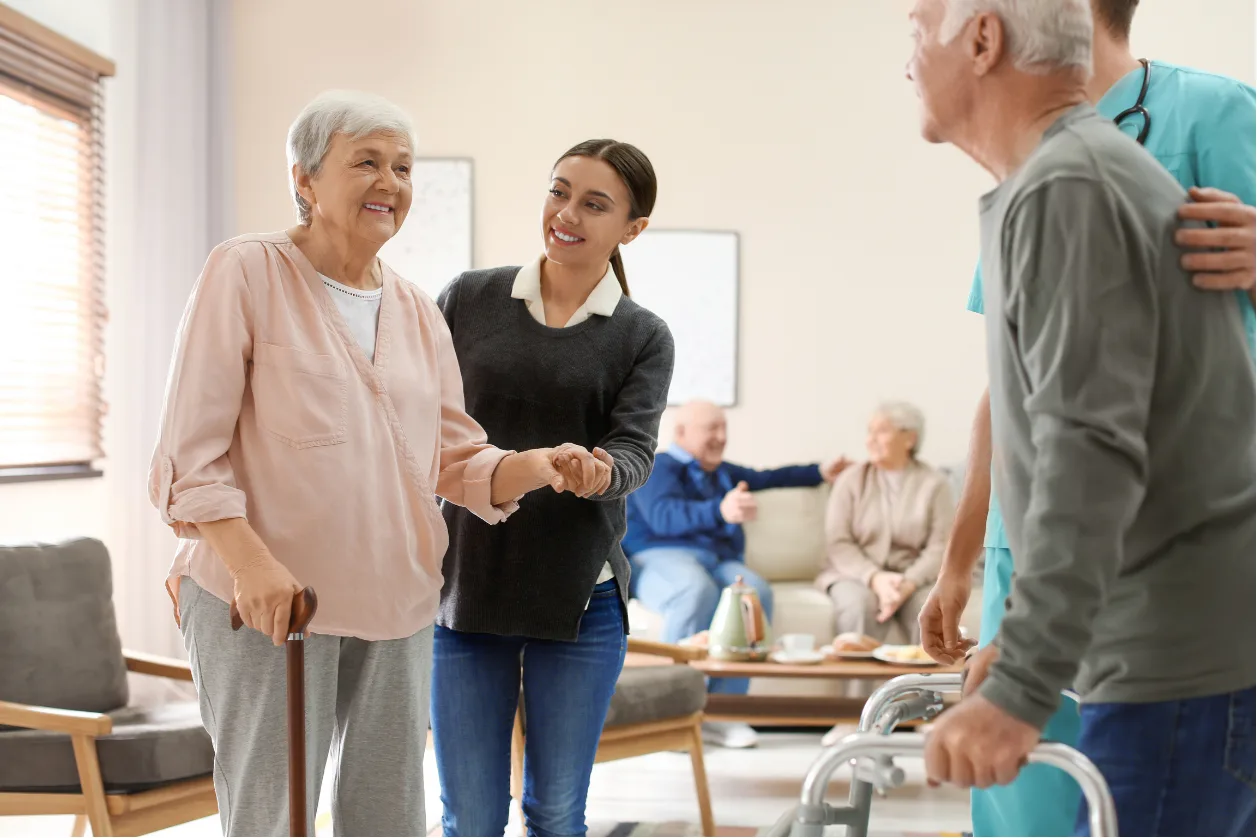 Caregivers assisting senior residents in daily activities